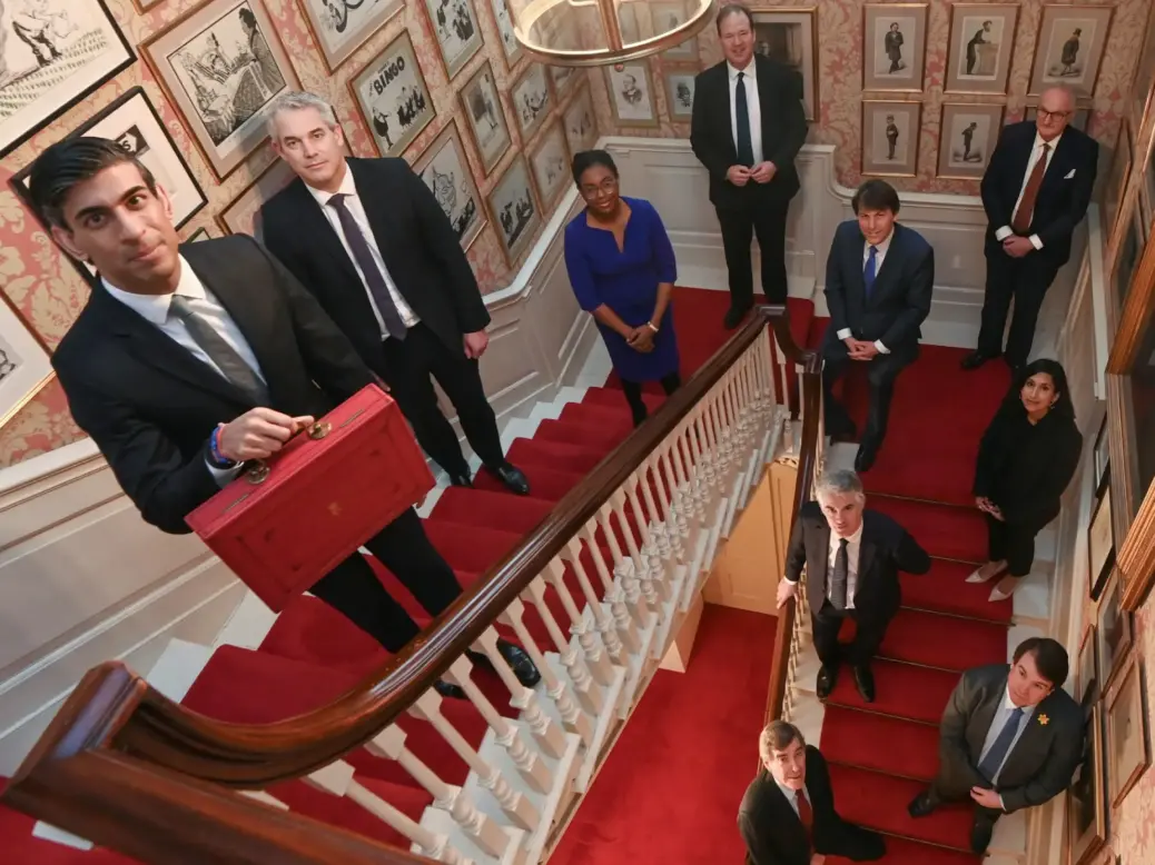 Lord Agnew (back right) who has replaced Sir Paul Marshall on the GB News board. Pictured here part of the Treasury team in March 2021. Then-Chancellor of the Exchequer Rishi Sunak holds the budget box as he poses with Chief Secretary to the Treasury Steve Barclay, Exchequer Secretary to the Treasury Kemi Badenoch, Financial Secretary to the Treasury Jesse Norman, Economic Secretary to the Treasury John Glen, Minister of State for Efficiency Theodore Agnew, PPS to Treasury Claire Coutinho, PPS to Chancellor James Cartledge, PPS to Chief Secretary Craig Williams and Government Whip and Lord Commissioner of HM Treasury David Rutley inside 11 Downing Street. Picture: PA Media/Toby Melville